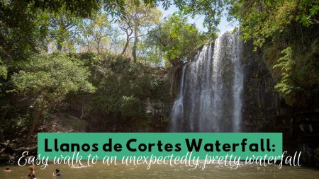 Llanos de Cortés Waterfall in Costa Rica with people swimming at its base